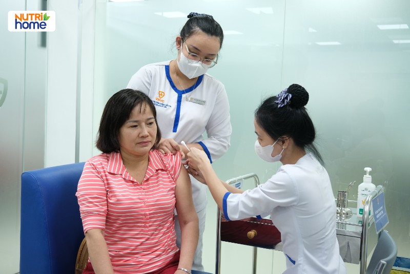 Nhân viên y tế đang tiêm vắc xin HPV cho phụ nữ tại trung tâm tiêm chủng