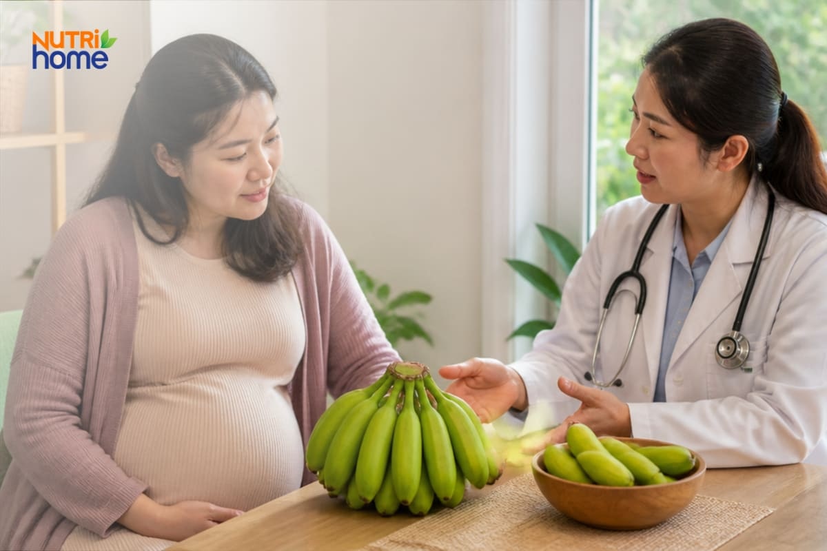 Bác sĩ tư vấn cho phụ nữ mang thai bên nải chuối xanh trên bàn